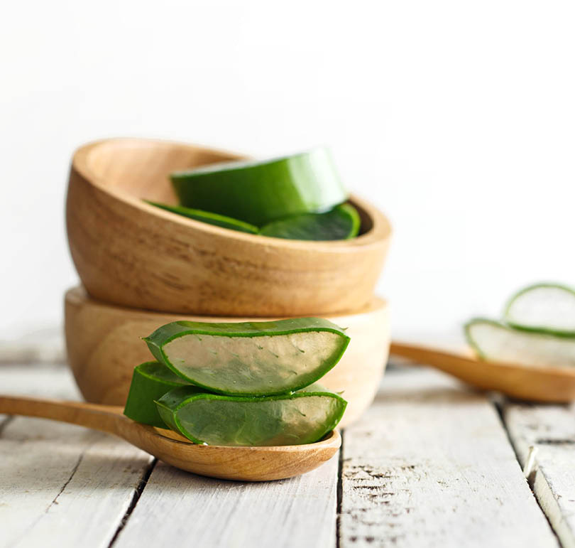 Fresh aloe vera on white wooden background
